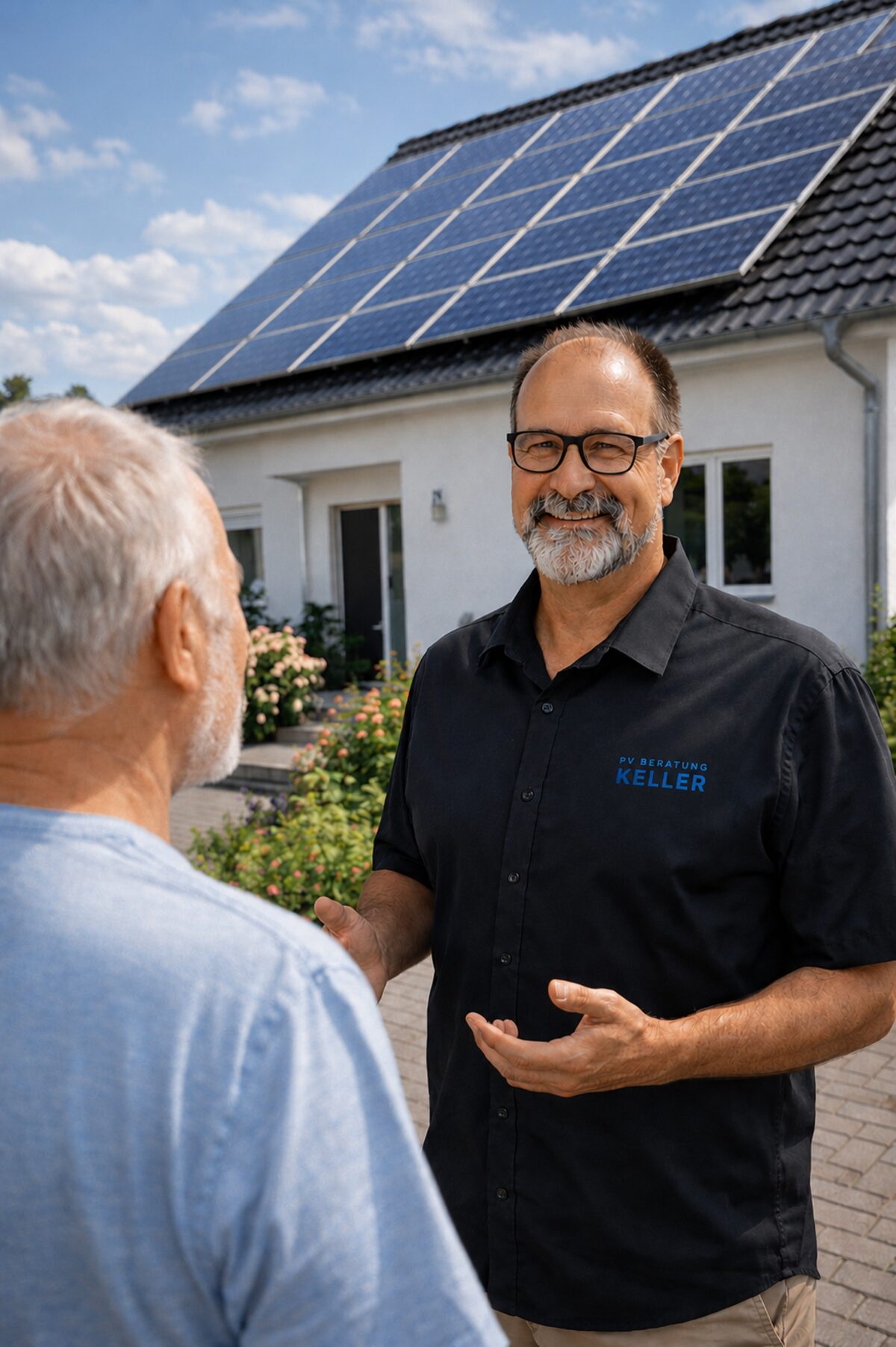 Dirk Keller im Beratungsgespräch vor Ort, im Hintergrund ein Haus mit Photovoltaikanlage auf dem Dach